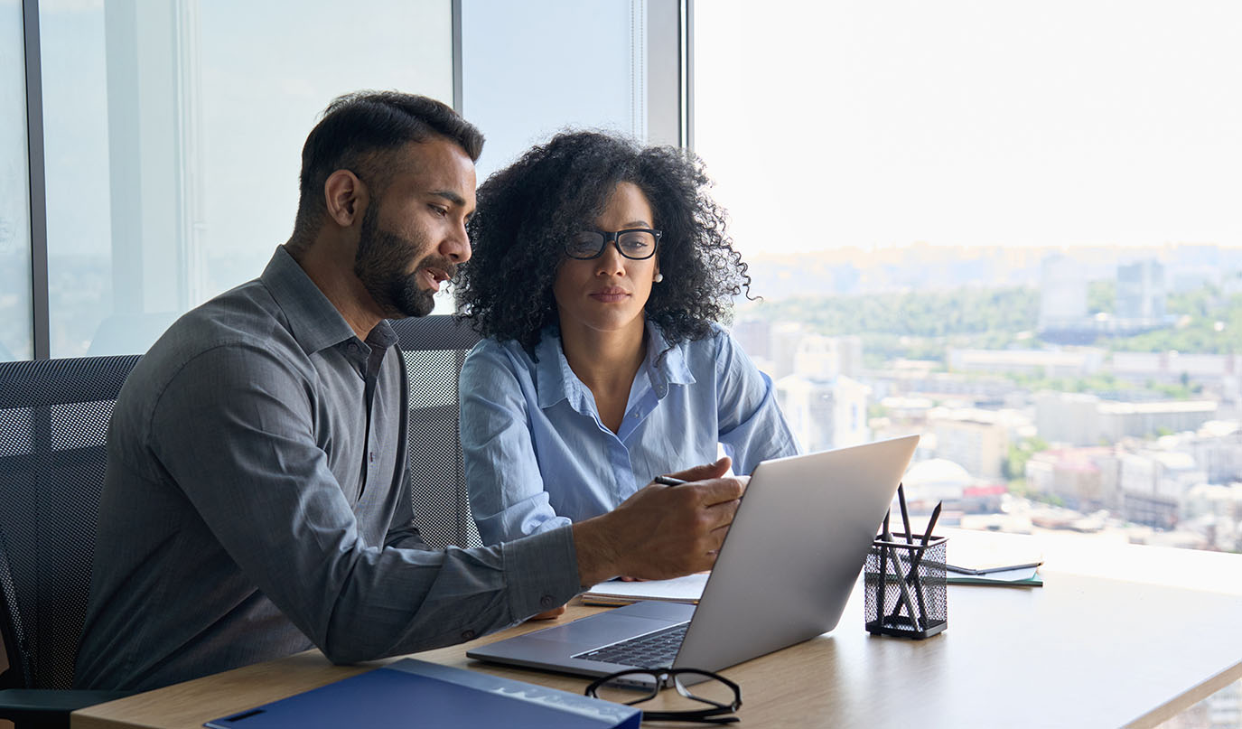 This is an image of of a male insurance agent giving advice to a client